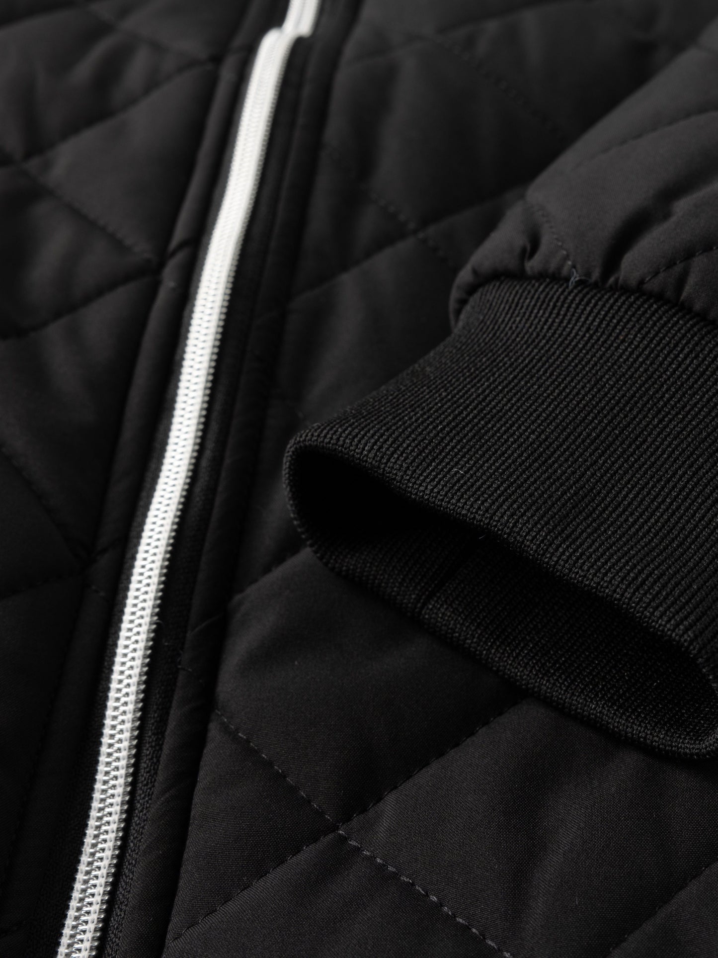Reuben Men's Quilted Bomber Jacket featuring warm plush lining and a classic design, perfect for stylish comfort in cold weather. 8