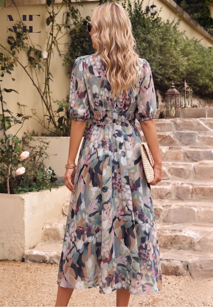 Roxy Women’s Midi Dress featuring a vibrant floral print and stylish puff sleeves, perfect for summer outings and casual gatherings. 1