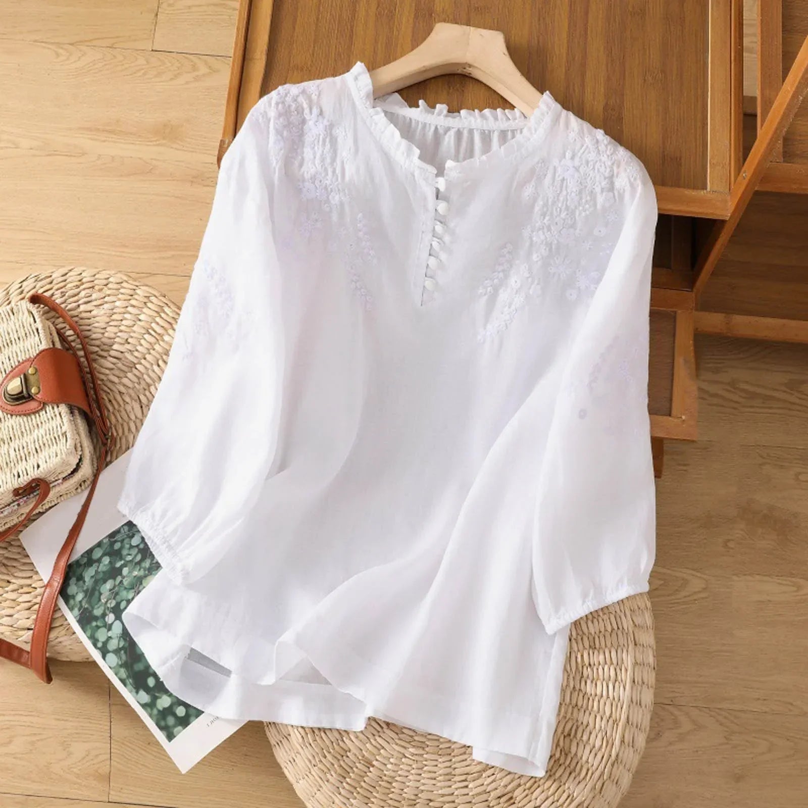 Sleek women's blouse featuring delicate floral embroidery and a stylish button-front design, perfect for both casual and formal occasions. 0
