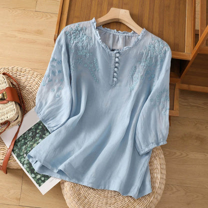 Sleek women's blouse featuring delicate floral embroidery and a stylish button-front design, perfect for both casual and formal occasions. 1