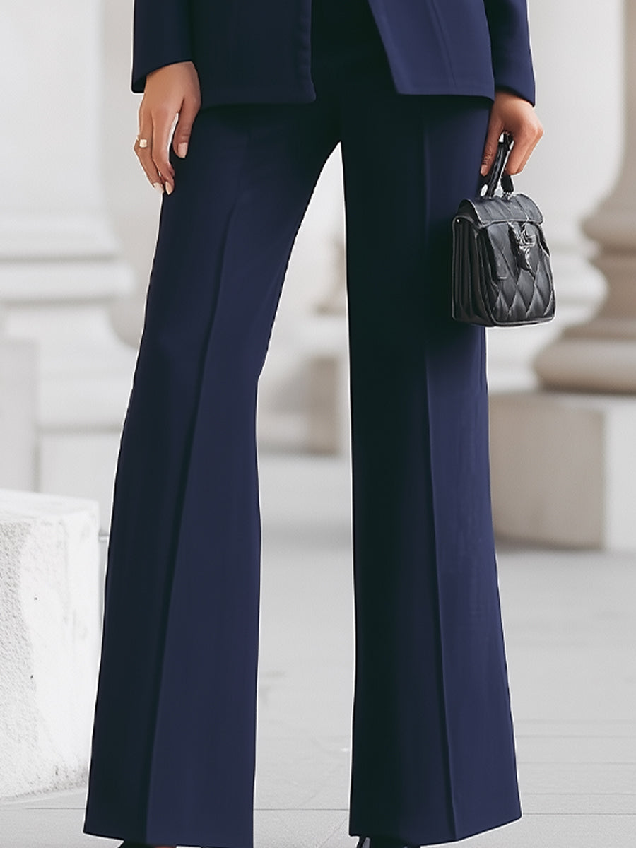 Sleek women's suit featuring a tailored blazer and elongated trousers, perfect for professional and formal occasions. 6