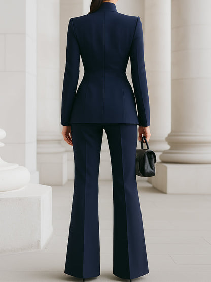 Sleek women's suit featuring a tailored blazer and elongated trousers, perfect for professional and formal occasions. 7