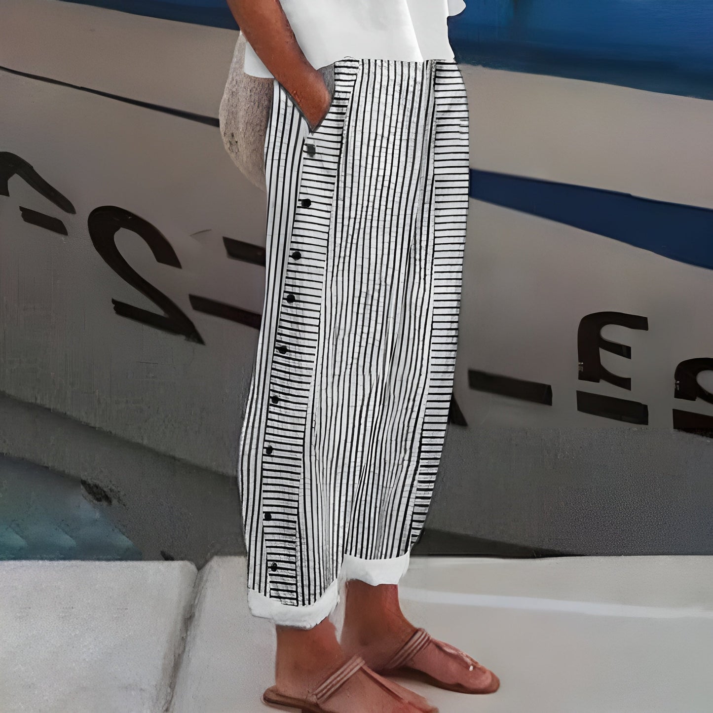 Sleek women’s trousers featuring stylish stripe panel detail and a chic cropped length, perfect for modern casual or office wear. 1