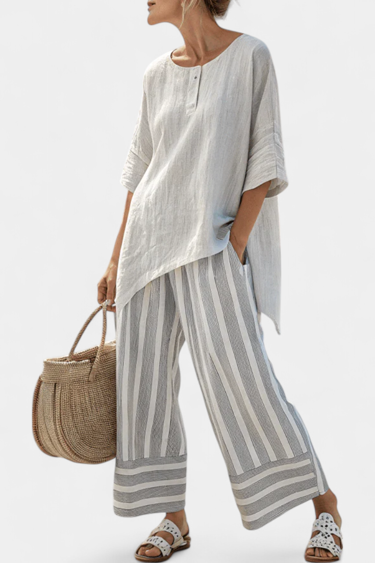 Talvora Women’s Two-Piece Set featuring an asymmetrical blouse and stylish striped wide-leg trousers, perfect for a chic and comfortable outfit. 0