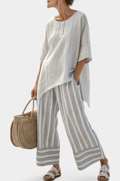 Talvora Women’s Two-Piece Set featuring an asymmetrical blouse and stylish striped wide-leg trousers, perfect for a chic and comfortable outfit. 0
