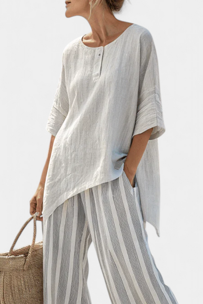 Talvora Women’s Two-Piece Set featuring an asymmetrical blouse and stylish striped wide-leg trousers, perfect for a chic and comfortable outfit. 1