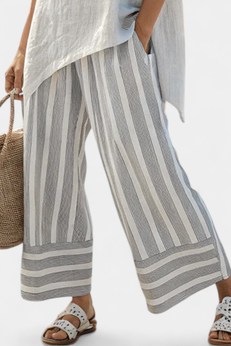Talvora Women’s Two-Piece Set featuring an asymmetrical blouse and stylish striped wide-leg trousers, perfect for a chic and comfortable outfit. 2
