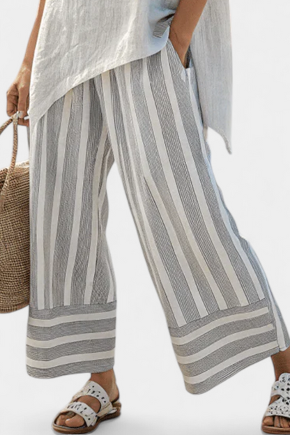 Talvora Women’s Two-Piece Set featuring an asymmetrical blouse and stylish striped wide-leg trousers, perfect for a chic and comfortable outfit. 2